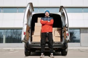 Fleet Management Camera Solutions: image of a delivery man standing behind a van with the doors open