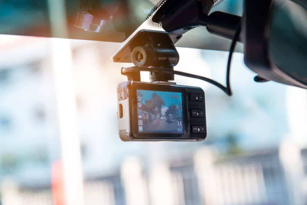 Dashboard camera mounted in a vehicle, showcasing remote monitoring capabilities for enhanced security and data collection in resource management.