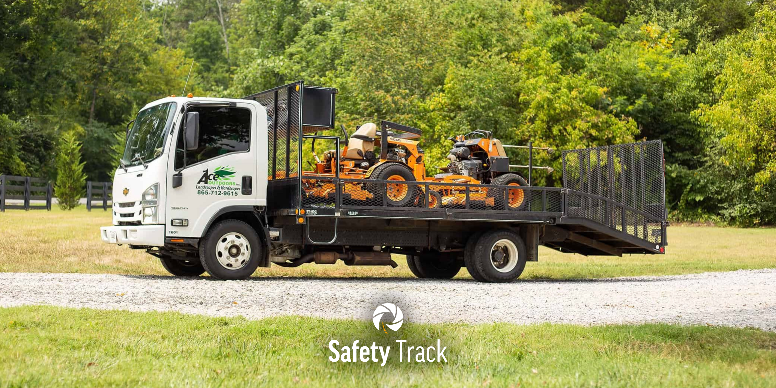 Landscaping vehicle with equipment, showcasing safety and efficiency for landscaping companies, featuring Safety Track branding.