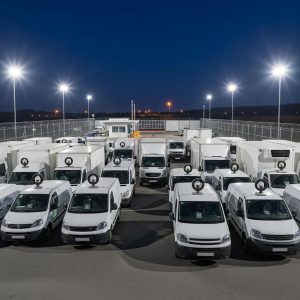 Modern commercial fleet vehicles equipped with advanced anti-theft technology in a secure parking area
